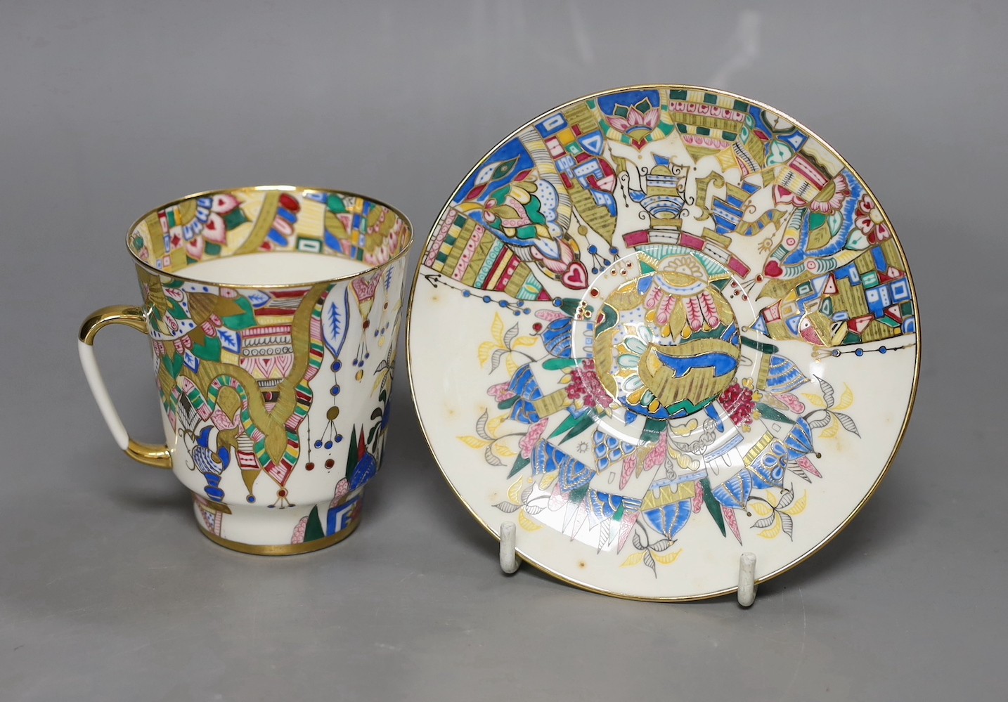 A Russian gilt enamel porcelain tea cup and saucer, cup 8cms high